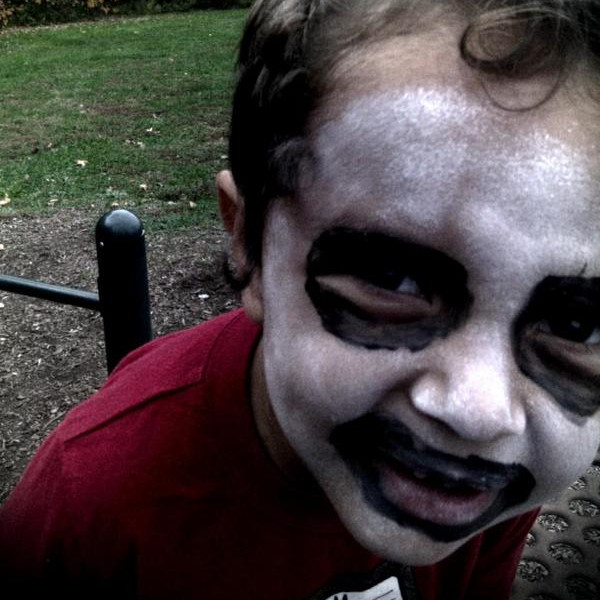My son wearing black and white face paint looking very blackmetal