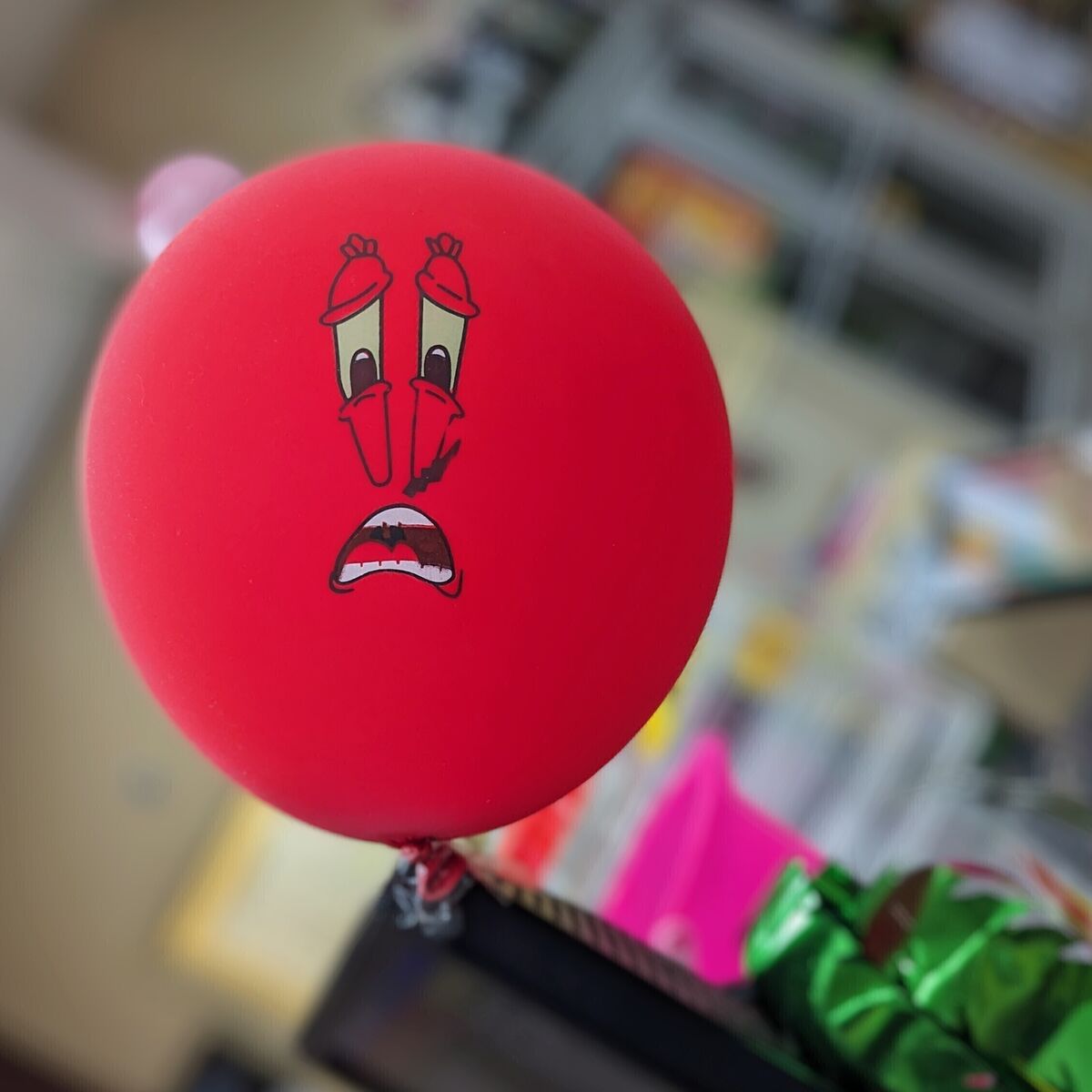 A red balloon of Mr. Krabs from SpongeBob with an agonizing look on his face.