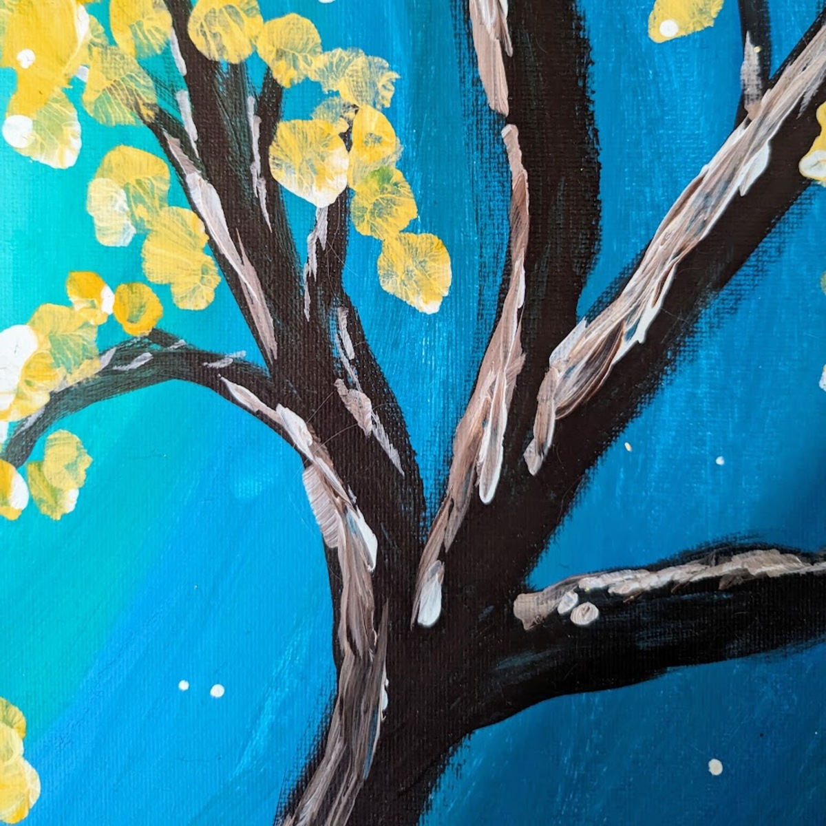 Up close view of a canvas, a dark brown tree with streaky highlights and a couple yellow blobs of pain posing as flowers.