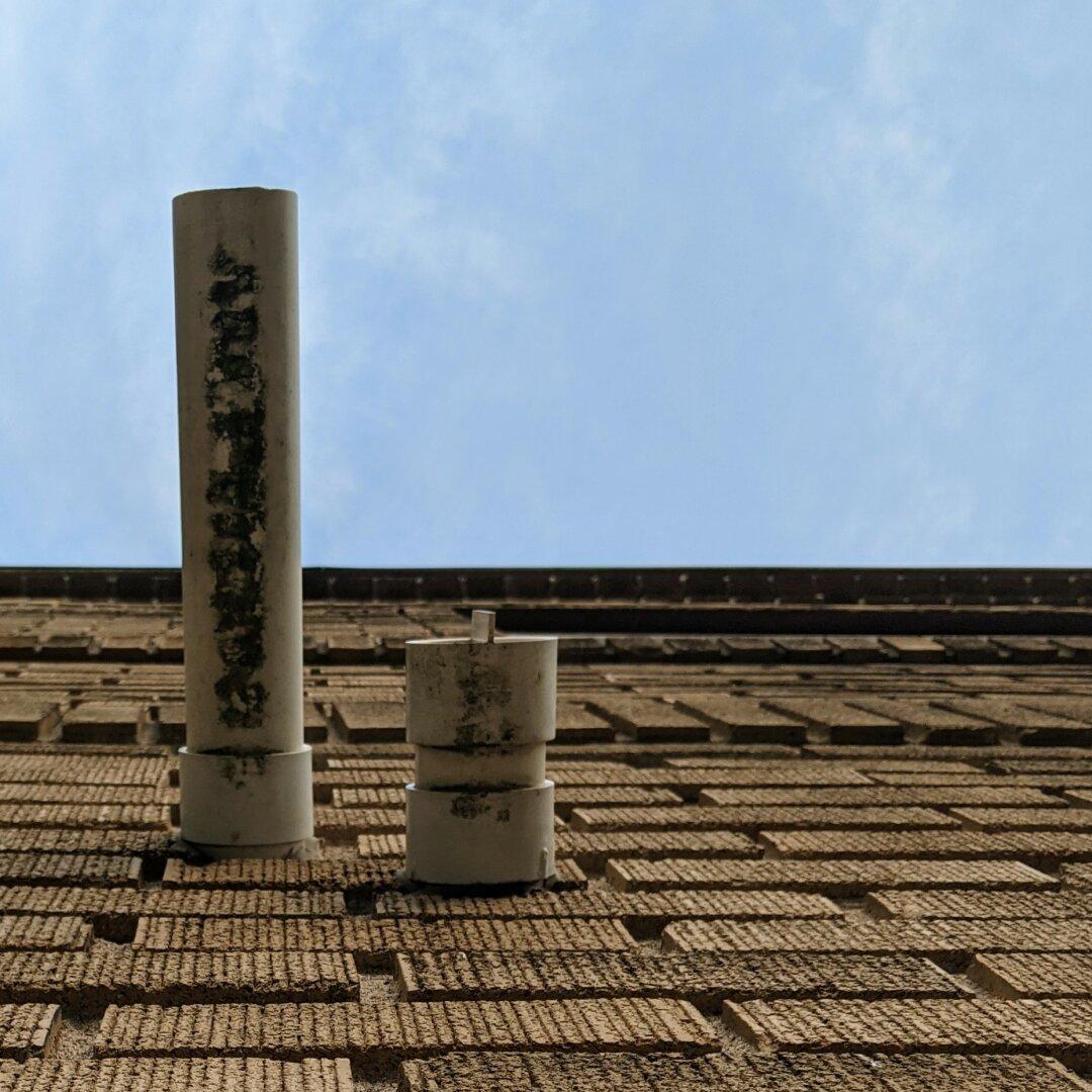 A PVC chimney on the top of a roof.