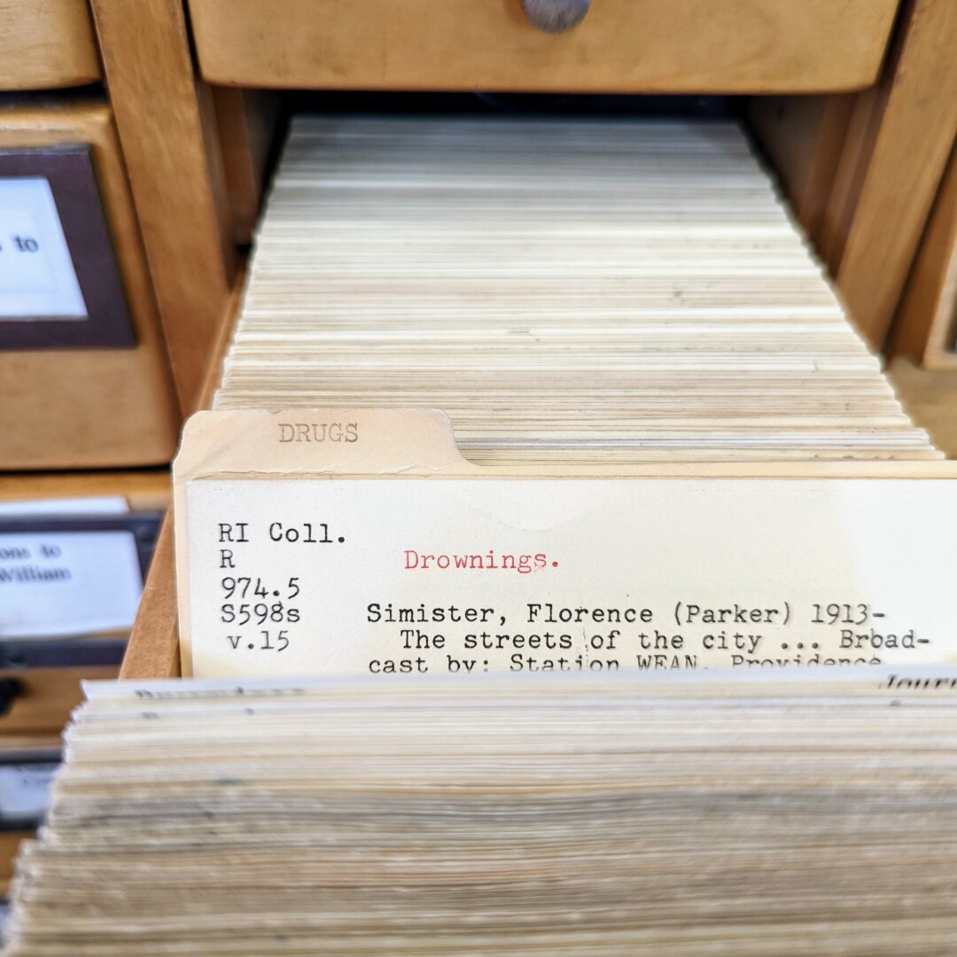 An open drawer of a card catalog. The next divider is labeled 'drugs' and the card that is shown is titled 'drownings.'