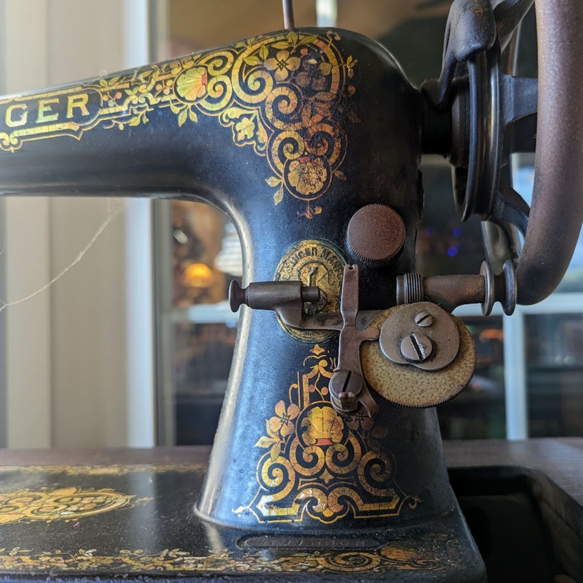 Gold and black decorated antique sewing machine from 1910