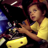 My son at a flight simulator video game having an amazing time