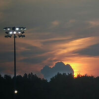 A sunset over a football field