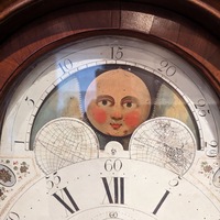 a clock face with a moon on it.