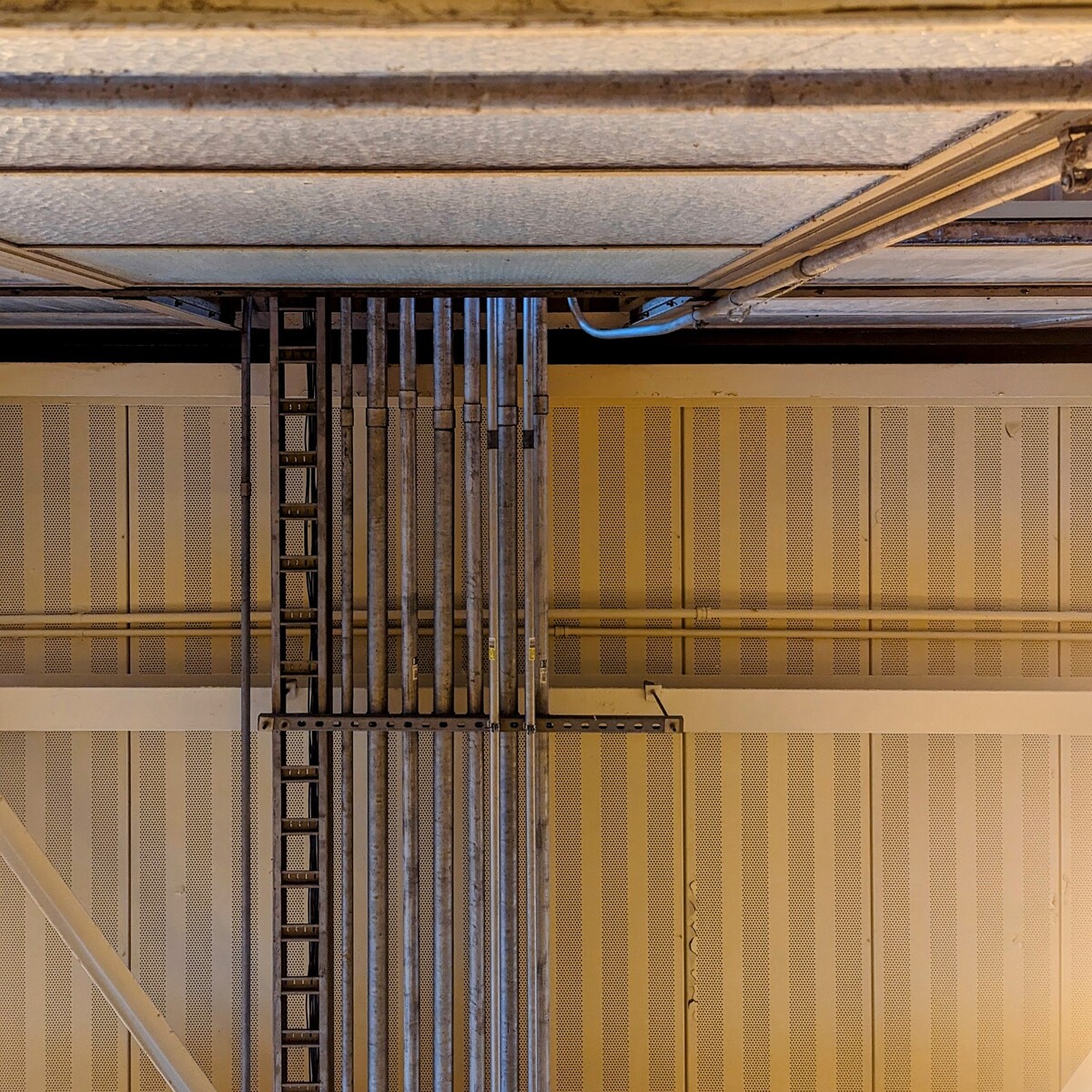 Look up at the ceiling, several pipes enter into the room