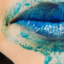 a close up of my son's lips covered in some blue mess